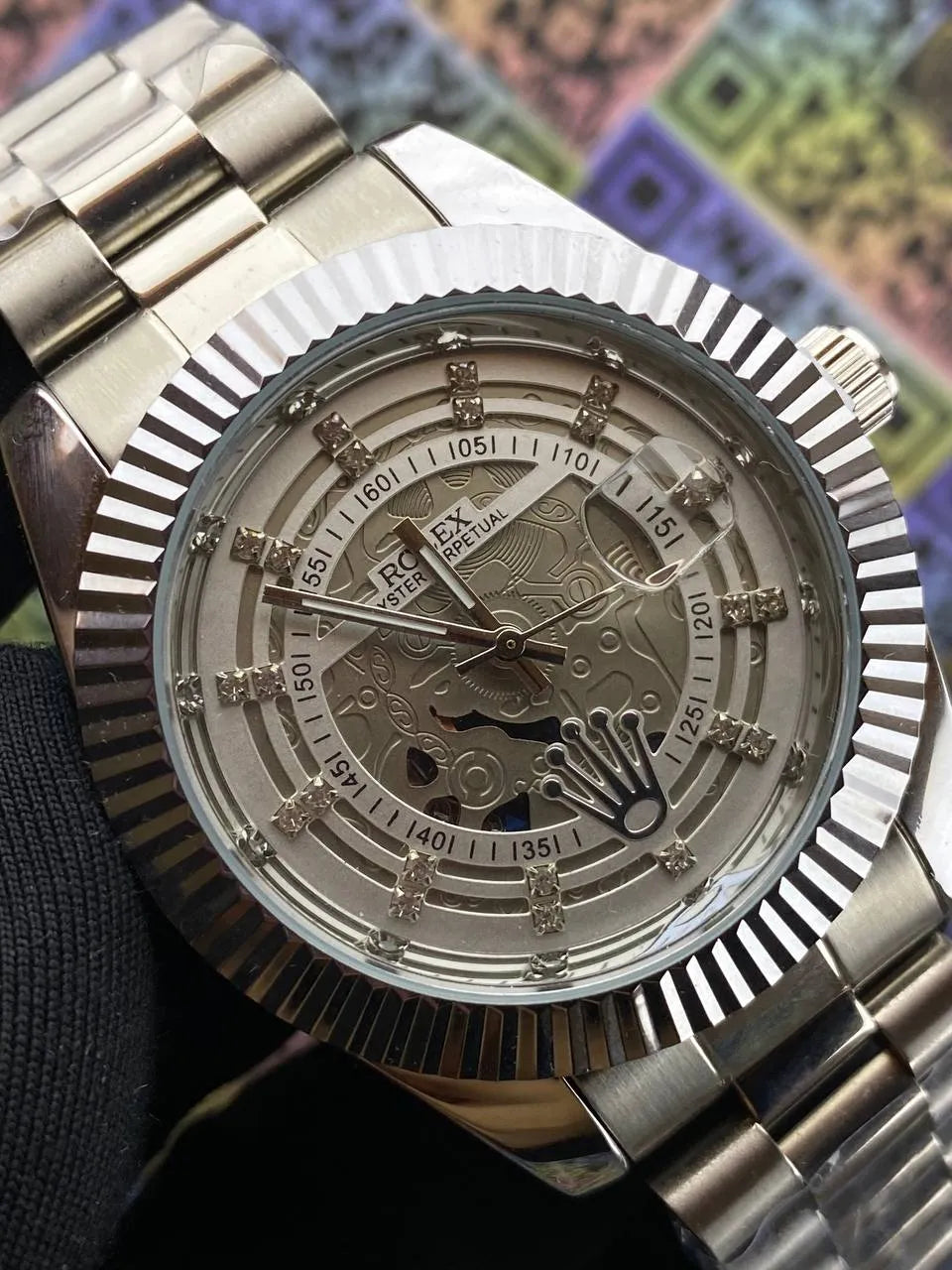 Luxury watch with intricate design on a colorful background