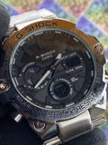 G-Shock Casio watch with metallic band on a colorful background