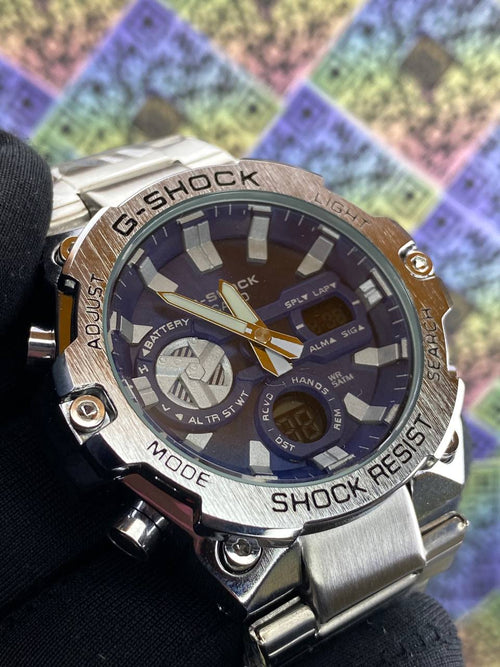 G-Shock watch with a metallic band on a colorful checkered background