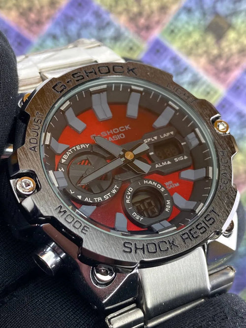 G-Shock watch with a metallic band on a colorful geometric pattern background