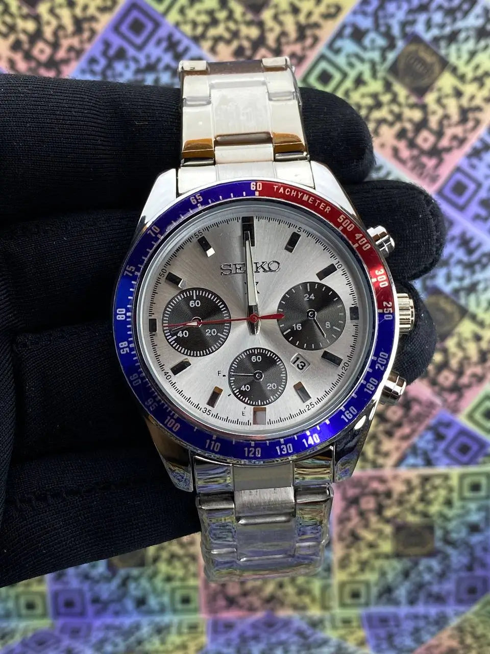 Seiko watch with a colorful bezel on a black background