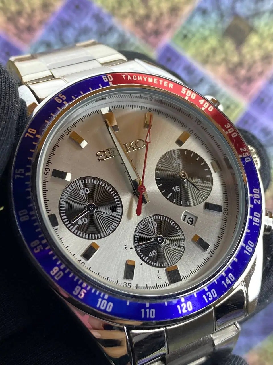 Seiko watch with a colorful geometric pattern in the background